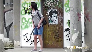 Girl in a hoodie takes a piss in public
