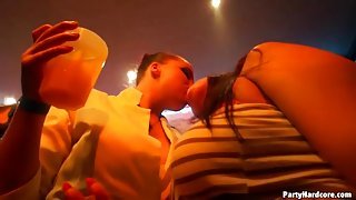 Drunken babes at a club suck on cock