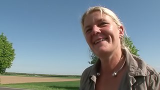 Sexy blonde with dimpled thighs masturbates erotically at the trunk of her car outdoors