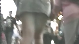 Upskirt view of long legged milf walking with her friend