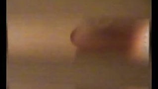 An alluring woman getting dressed in front of a window