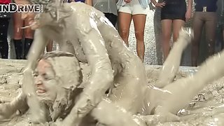 Wild brunette with a slim sexy body having a catfight in a mudbath
