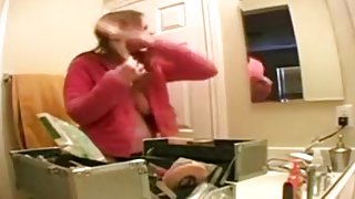 Breasty blondy beauty puts on makeup