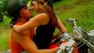 Biker with a babe on his bike fills her fuck hole with cock