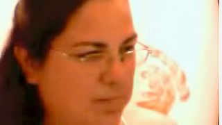 Chubby brunette wearing glasses shows her natural boobs