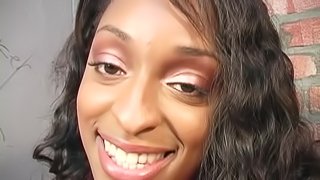 Ebony-skinned babe with an awesome body sucking a big white cock through a glory hole