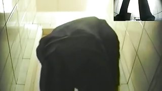 An alluring woman caught pissing on a spy cam video