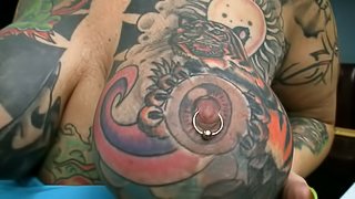 Tattooed Blackwidow gets her pierced pussy drilled