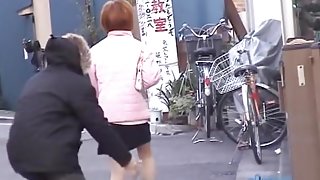 Man approaches cute girl and sharks her skirt up