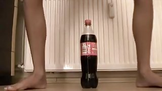 Small  immature tries to ride a coke bottle