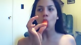 Lewd brunette poking a lollipop into her shaved pussy